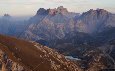Mountain landscape with lakes and paths in evening light